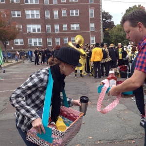 There were two people dispensing catsup and mustard to the crowds while they paraded.
